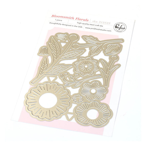 Floral metal cutting dies on a pink card with 'Pinkfresh Studio' branding.