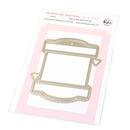 Metal craft die shaped like a spool on a pink card with branding information.