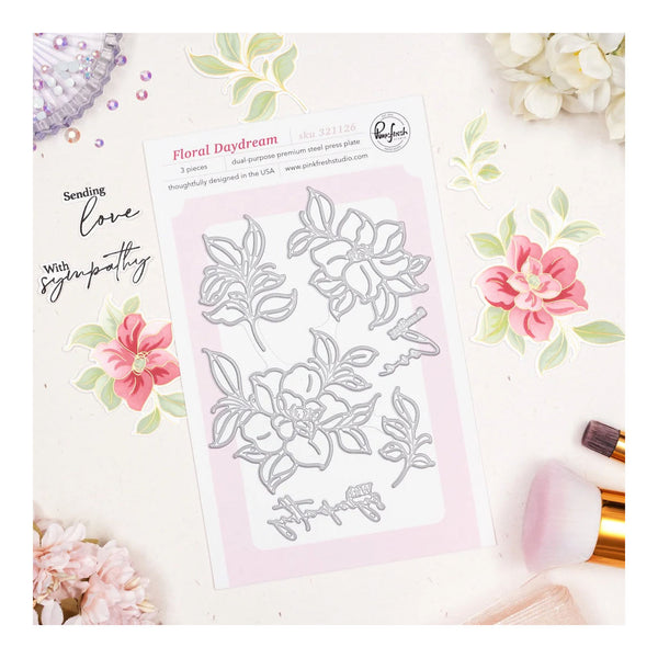 Floral die-cutting set on a decorative card with flowers and text