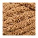 Close-up of a textured brown fabric with a knitted pattern
