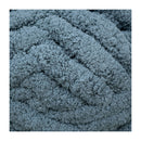 Close-up of a textured blue fabric with a braided pattern