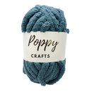 Blue skein of yarn with a 'Poppy Crafts' label on a white background