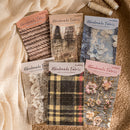 Collection of handmade fabric samples with packaging on a textured surface