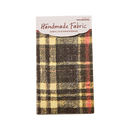 Plaid fabric sample with 'Handmade Fabric' label on a white background