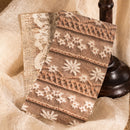 Decorative fabric with lace and floral patterns on a textured surface