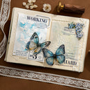 Open book with decorative elements including butterflies and lace on a brown surface.