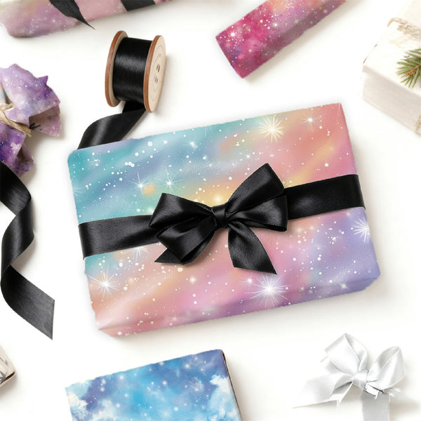 Gift box with galaxy-themed wrapping paper and black ribbon on a white background