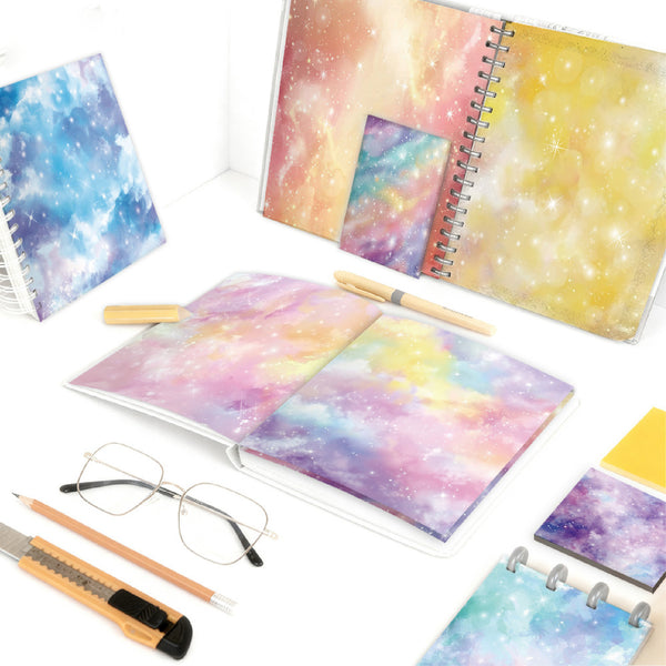 Colorful spiral-bound notebooks with galaxy design on a white background