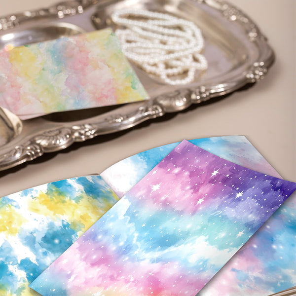 Colorful galaxy-patterned paper on a silver tray with pearls