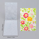 Transparent embossing folders with floral design and measurements on a gray background