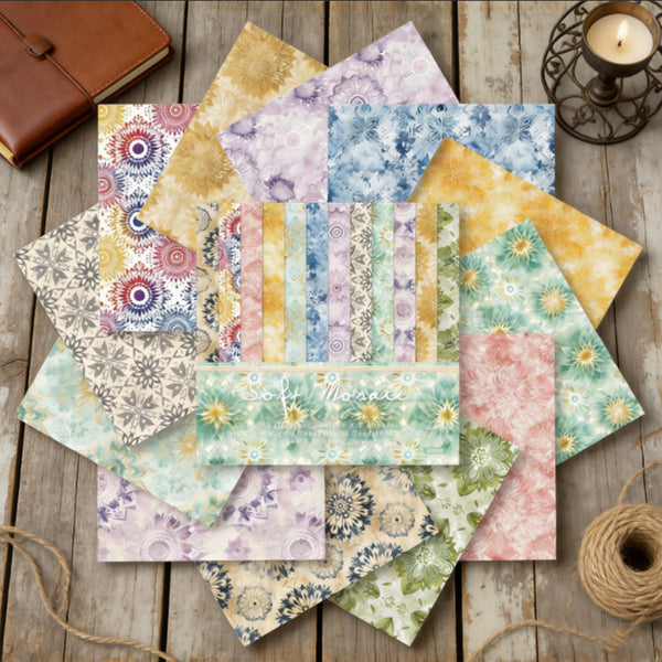 Collection of patterned paper sheets on a wooden surface with a candle and leather-bound book.