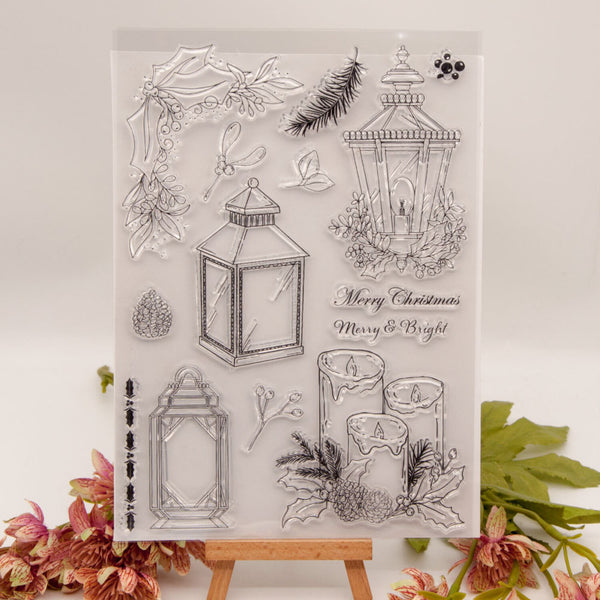 Clear stamp set with Christmas-themed designs including lanterns and candles on a white background.