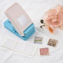 Blue and beige paper punch with cut-out shapes on a white surface with flowers.