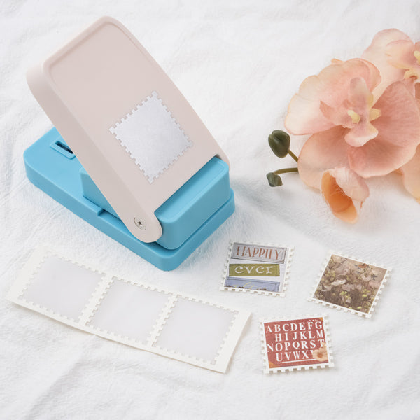 Blue and beige paper punch with cut-out shapes on a white surface with flowers.