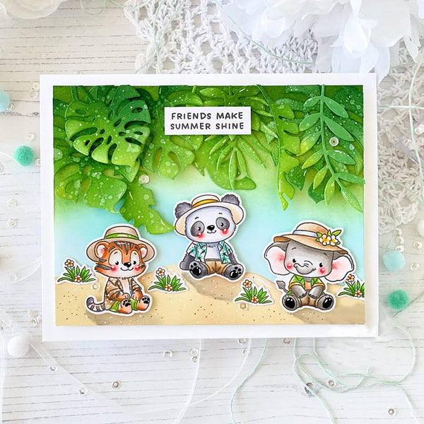 Card with cartoon animals and tropical leaves, featuring text 'Friends make summer shine'.