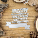 Decorative text cutout with phrases on a wooden surface with natural elements.