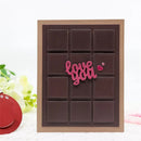 Chocolate bar-shaped card with 'love you' text on a white background