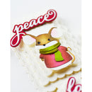 Decorative cake with a mouse figure wearing a pink sweater and green scarf, and the word 'peace' above.