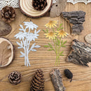 Decorative cutouts of flowers and leaves on a wooden surface with pinecones and wood pieces.
