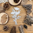 Metallic floral die cut on a wooden surface with natural elements