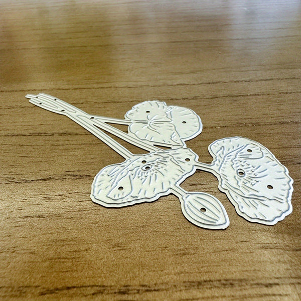 Decorative metal flower-shaped object on a wooden surface