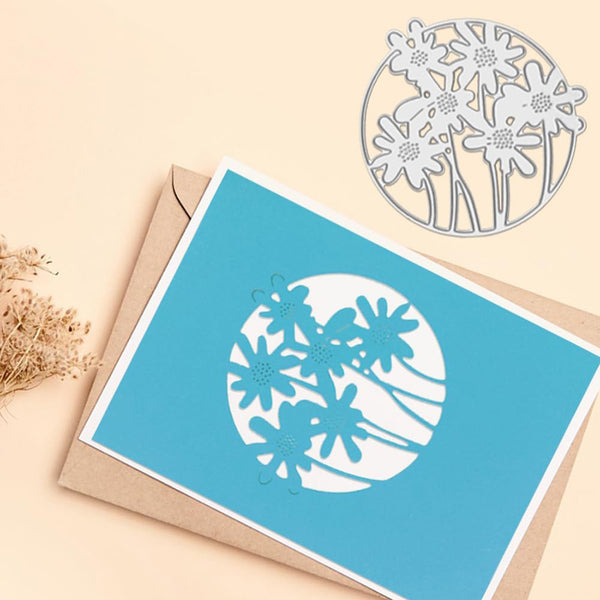 Blue card with floral cutout design on a beige background