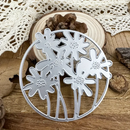 Metal floral cutting die on a wooden surface with lace fabric