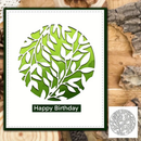 Green leaf-shaped birthday card on a wooden surface