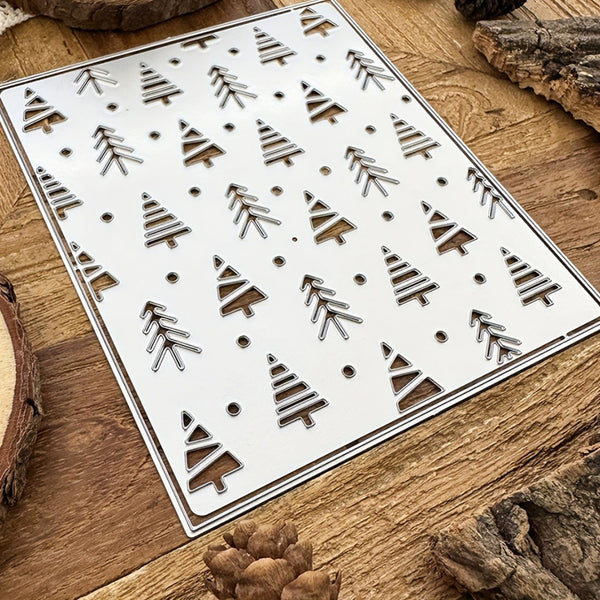 Metal stencils with tree patterns on a wooden surface