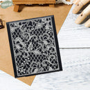 Decorative metal cutting die on a wooden surface with a hand visible