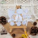 Set of metal cutting dies with ocean-themed designs on a wooden stand, surrounded by decorative elements.