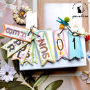 Colorful letter and number banner with decorative elements on a white surface.