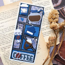 Decorative coffee-themed bookmark with blue and brown elements on a textured surface.