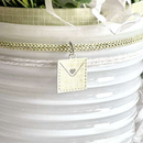 Necklace with a pendant hanging from a decorative basket