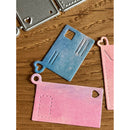 Colorful metal die cut shapes on a wooden surface