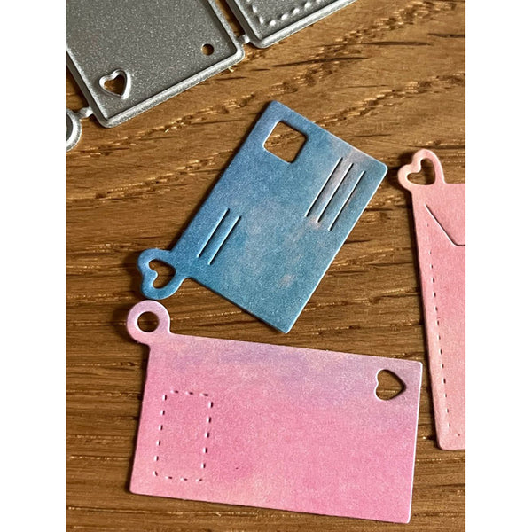 Colorful metal die cut shapes on a wooden surface