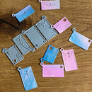 Set of gradient-colored card holders on a wooden surface