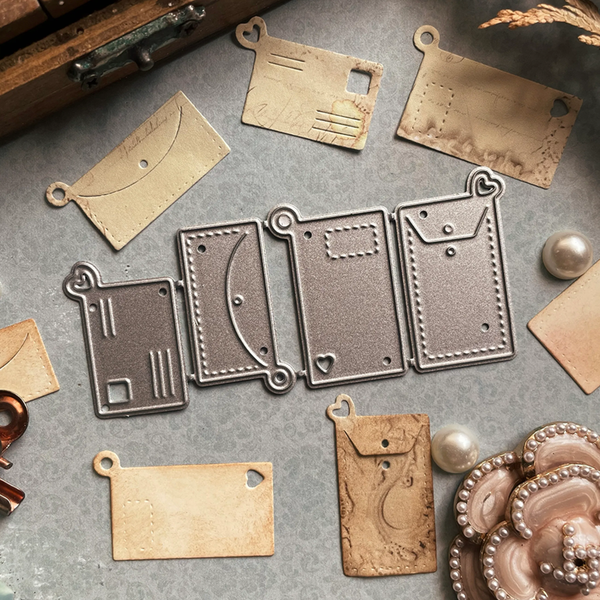 Metal die cutters and embossers on a gray surface with leather tags.