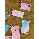 Colorful paper cutouts of envelopes and cards on a wooden surface
