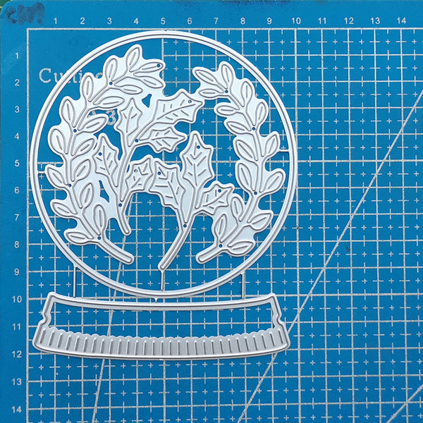 Metal die cutters with leaf design on a blue cutting mat
