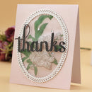 Greeting card with floral design and 'thanks' text on a pink background