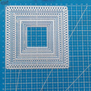 Decorative square cutout on a blue cutting mat with grid lines