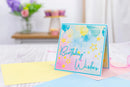Colorful birthday card with 'Birthday Wishes' text on a light surface.