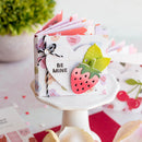 Small book with a strawberry design and 'BE MINE' text on a white stand.