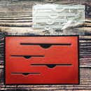 Red card with cut-out sections on a wooden surface