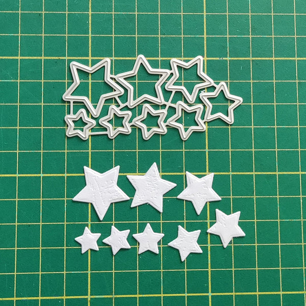White star-shaped cutouts on a green grid background