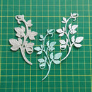 Decorative leaf cutouts on a green grid background