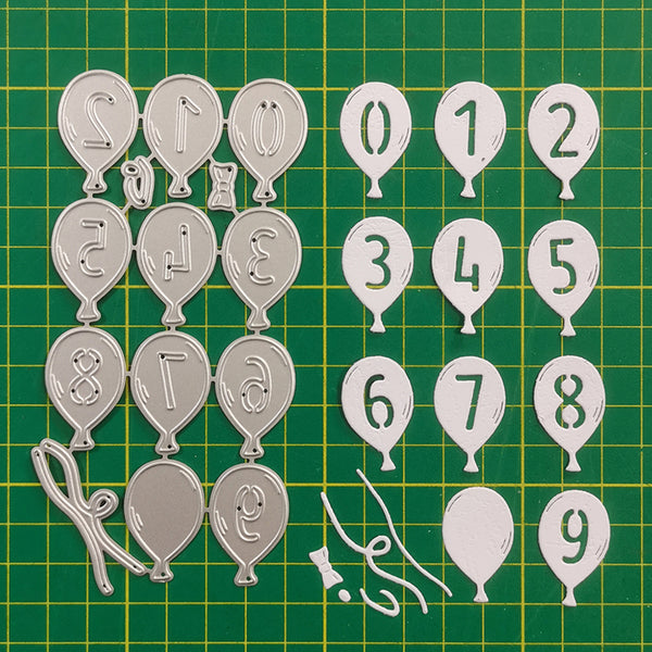 Metal balloon-shaped numbers and letters on a green grid background