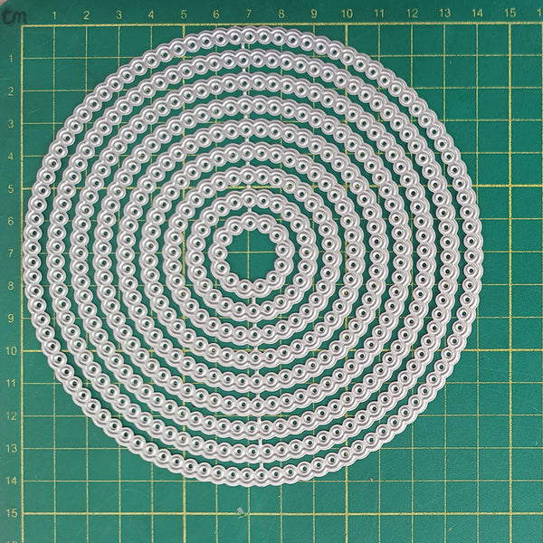Circular pattern of white strings on a green grid background