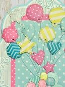 Colorful paper balloons on a light blue background with star and heart shapes.